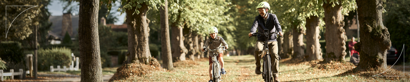 Picture of a person living with epilepsy riding a bike with his son 