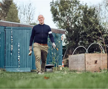 Picture of a person living with epilepsy working in his garden
