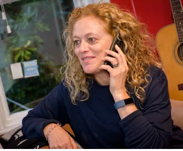 Picture of a person living with psoriasis having a phone call 